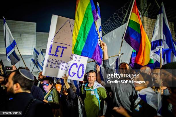 Israeli protestors wave flags during an anti Judicial reform protest. Israeli Prime Minister Benjamin Netanyahu on Thursday vowed to mend the rift in...