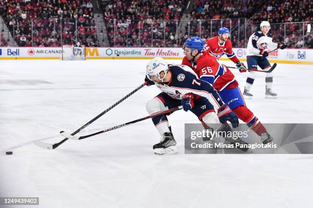 Sean Kuraly of the Columbus Blue Jackets and Jesse Ylonen of the Montreal Canadiens skate after the puck during the first period at Centre Bell on...
