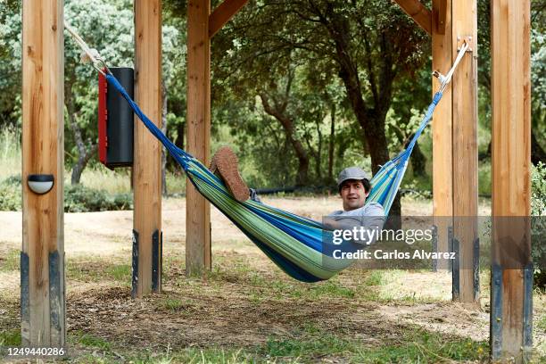 Man rests in a hammock at the Monte Holiday campsite on June 13, 2020 in Gargantilla de Lozoya y Pinilla de Buitrago, Spain. The campsite, which had...