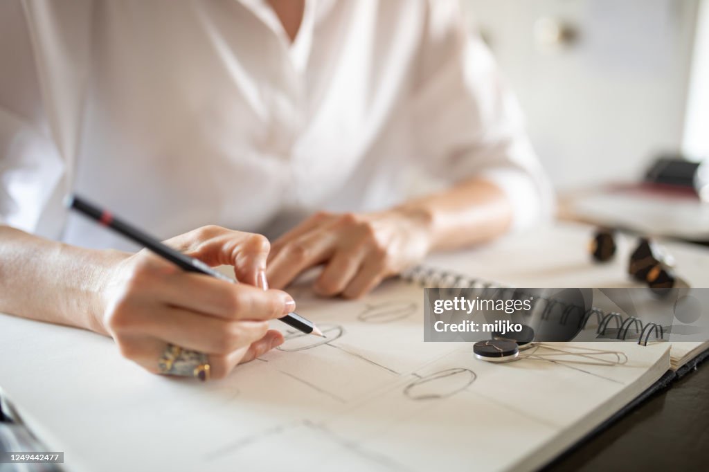 Woman designing jewelry in her atelier