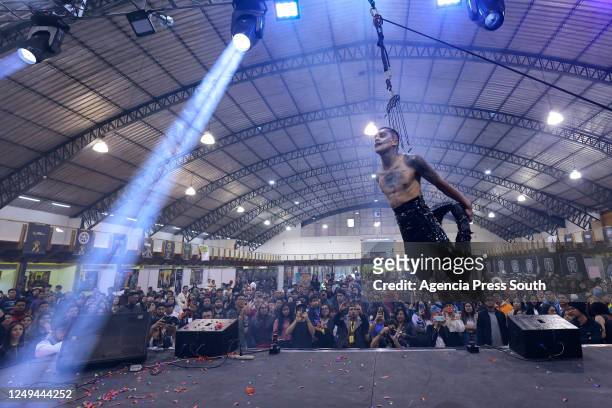 Juan Vehemente is suspended from a rope as part of a performance during the 7th International Tattoo Convention Mitad del Mundo at Centro de...