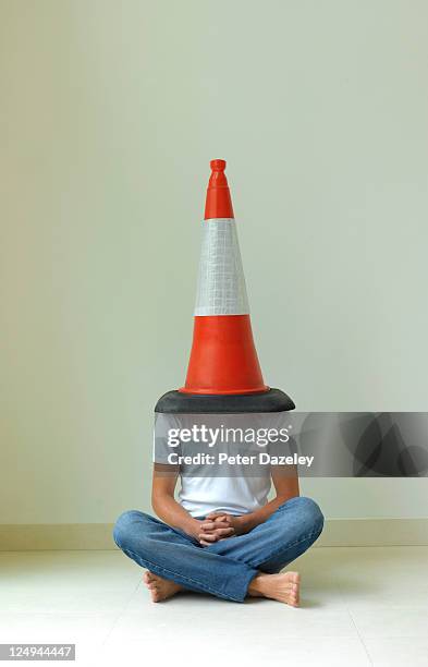 teenager with traffic cone on his head - dunce cap stock-fotos und bilder