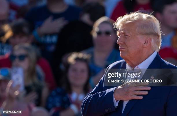 Former U.S. President Donald Trump holds his hand over his heart during a 2024 campaign rally in Waco, Texas, March 25, 2023. - Trump held the rally...