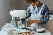 Happy Woman Using a Stand Mixer to Make Cookie Dough