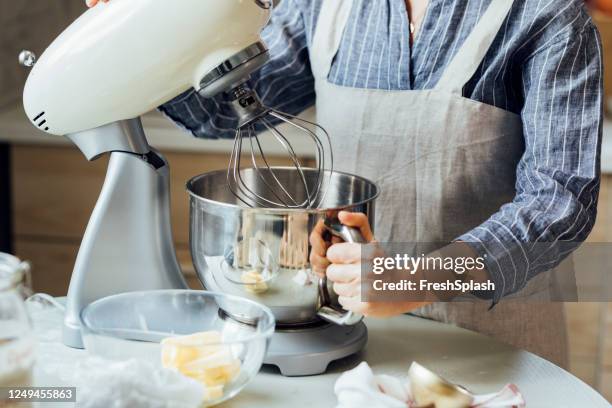 unrecognizable woman using a stand mixer in the kitchen - electric whisk stock pictures, royalty-free photos & images