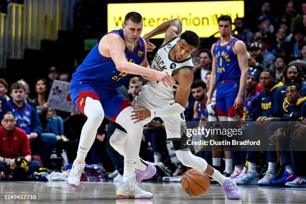 Giannis Antetokounmpo of the Milwaukee Bucks steals the ball from Nikola Jokic of the Denver Nuggets in the second half of a game at Ball Arena on...