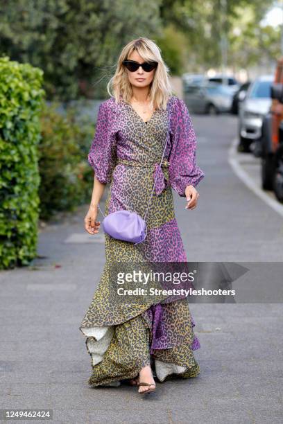 Influencer Gitta Banko, wearing a purple and light green long wrap dress by Delicatelove, a purple mini pouch bag by Bottega Veneta, sandals by...
