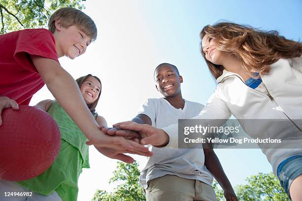 neighborhood kids playing and giving high five - kickball stock pictures, royalty-free photos & images