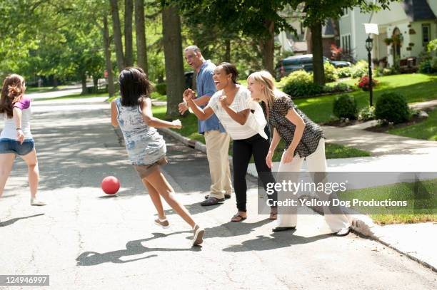 parents cheering neighborhood kids playing - kickball stock pictures, royalty-free photos & images