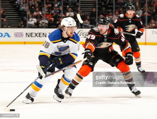 Robert Thomas of the St. Louis Blues and Max Jones of the Anaheim Ducks battle for the puck during the second period at Honda Center on March 25,...