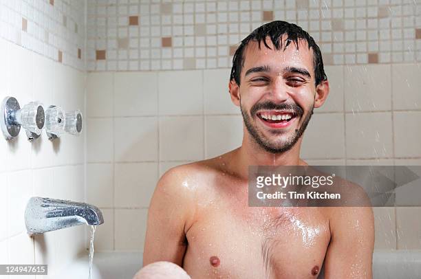 happy man in bathtub, smiling - solo un uomo di età media foto e immagini stock