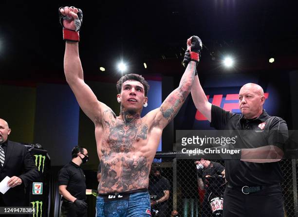 Andre Fili celebrates after his victory over Charles Jourdain in their featherweight fight during the UFC Fight Night event at UFC APEX on June 13,...