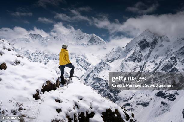 young asian woman trekker standing on trail in langtang valley and looking to snow himalaya mountains, nepal - nepal people stock pictures, royalty-free photos & images