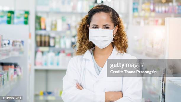 pharmacist with protection mask looking at camera - pharmacy mask stock pictures, royalty-free photos & images