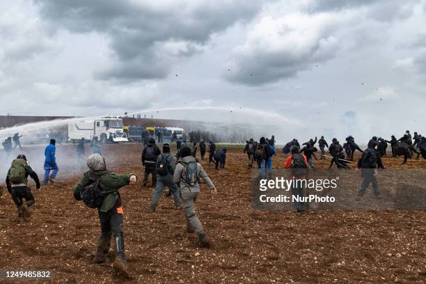 Protesters, surrounded by tear gas, clash with riot mobile gendarmes during a demonstration called by the collective ''Bassines non merci'', the...