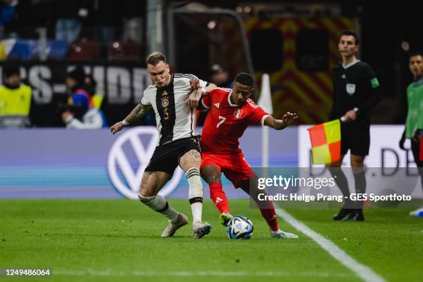David Raum of Germany in action with Andy Polo of Peru during an international friendly match between Germany and Peru at MEWA Arena on March 25,...