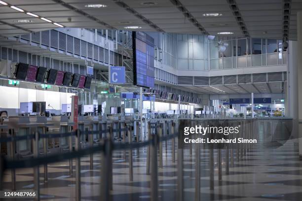 Departures hall stands nearly empty on the first day of a two-day strike by baggage and security staff at Munich Airport on March 26, 2023 near...