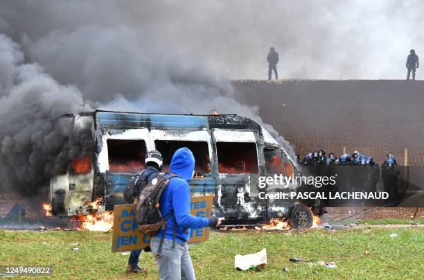 French gendarme vehicle burns during clashes as part of a demonstration called by the collective "Bassines non merci", the environmental movement...