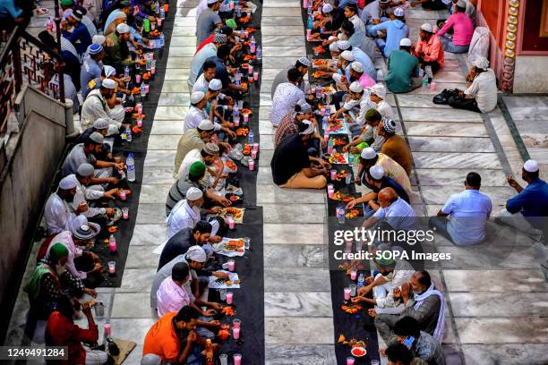 Muslim devotees break their fast at the Nakhoda Mosque during Ramadan. Muslims around the world are required not to eat, drink or have sexual acts...