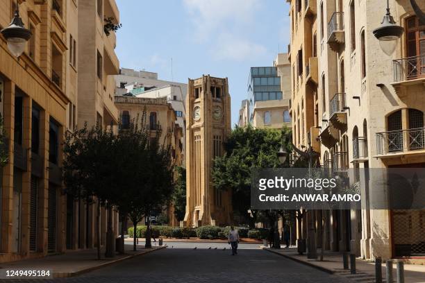 The landmark clock tower in front of the parliament building in Beirut's downtown district indicates the time on March 26 after Lebanon's government...