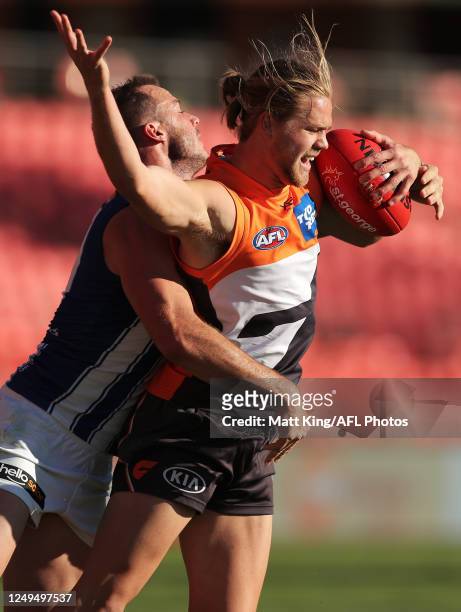 Harry Himmelberg of the Giants is challenged by Josh Walker of the Kangaroos during the round 2 AFL match between the Greater Western Sydney Giants...