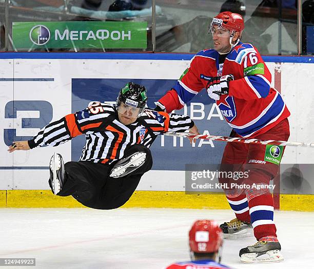 Referee Alexei Belov collapses with Alexander Guskov of the CSKA Moscow during the game against the Avangard Omsk during the KHL Championship...