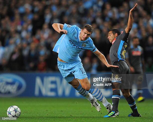 Manchester City's Bosnian forward Edin Džeko vies with Napoli's Uruguayan midfielder Walter Gargano during the UEFA Champions league group A football...
