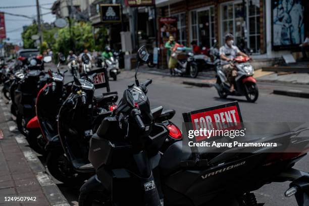 Motorcycles for rent are seen at a main road on March 26, 2023 in Seminyak, Bali, Indonesia. Indonesian island of the gods plans to enact some rules...