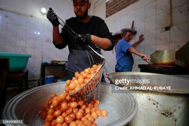 Confectioners prepare traditional sweets during the Muslim holy fasting month of Ramadan in the Sadria district of central Baghdad, on March 26, 2023.