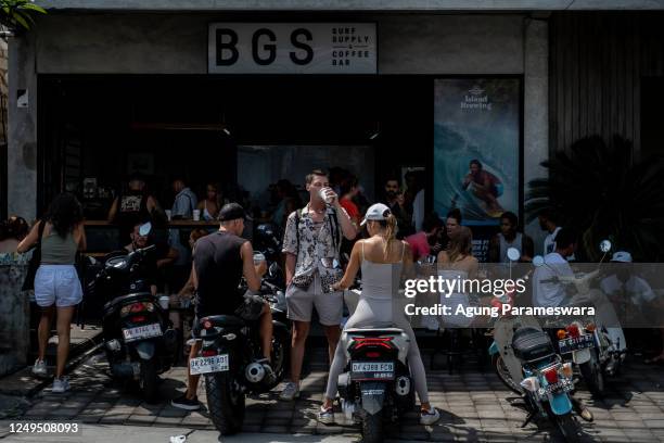 Foreigner tourists park the motorcycles infront of a coffee shop at a main road on March 26, 2023 in Canggu, Bali, Indonesia. Indonesian island of...