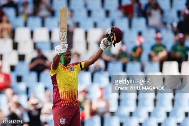 West Indies' Johnson Charles celebrates after scoring a century during the second T20 international cricket match between South Africa and West...