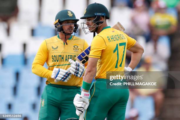 South Africa's Quinton de Kock speaks to South Africa's Reeza Hendricks between overs during the second T20 international cricket match between South...