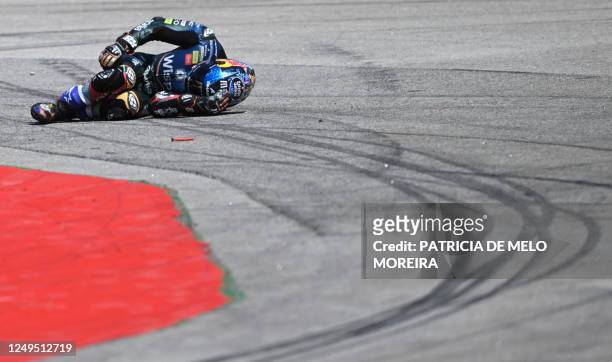 Aprilia Portuguese rider Miguel Oliveira lies on the track after crashing with Honda Spanish rider Marc Marquez during the MotoGP race of the...