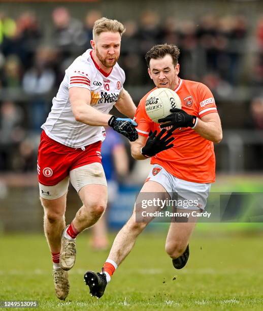 Tyrone , United Kingdom - 26 March 2023; Callum Cumiskey of Armagh in action against Frank Burns of Tyrone during the Allianz Football League...