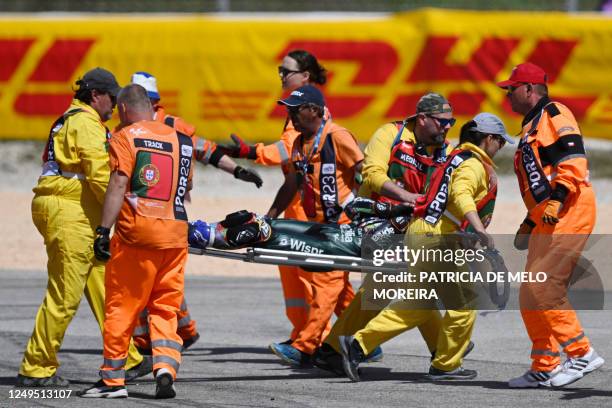 Track staff members carry Aprilia Portuguese rider Miguel Oliveira on a stretcher after crashing during the MotoGP race of the Portuguese Grand Prix...