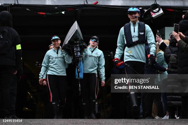 Led by the cox, Jasper Parish members of the Cambridge boat leave their boathouse, ahead of the 77th annual women's boat race between Oxford...