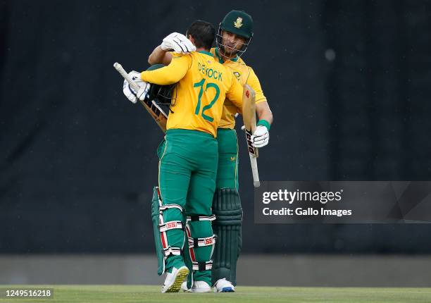 Quinton de Kock of South Africa celebrates his century with Reeza Hendricks during the 2nd KFC T20 International match between South Africa and West...