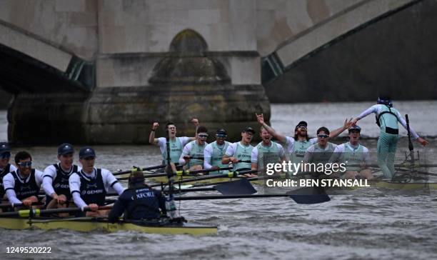 The Cambridge crew celebrate after their victory in the 168th annual men's boat race between Oxford University and Cambridge University on the River...