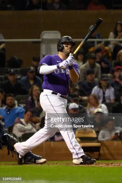 Colorado Rockies Infield Mike Moustakas hits a fly ball during a spring training game between the Colorado Rockies and Cleveland Guardians on March...