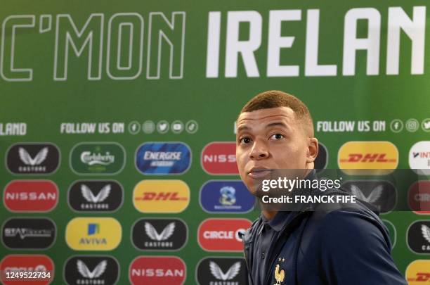 France's striker Kylian Mbappe leaves after attending a France football team press conference at Aviva Stadium in Dublin, Ireland on March 26 the eve...