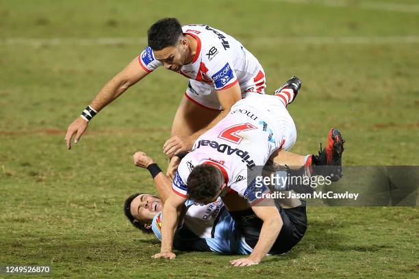 Mawene Hiroti of the Sharks is tackled by Adam Clune of the Dragons and Corey Norman of the Dragons during the round five NRL match between the St...