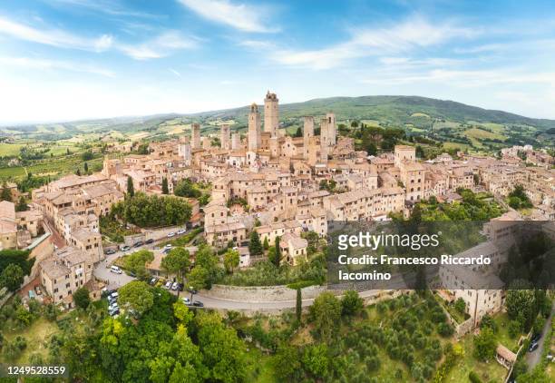 san gimignano from above, panoramic aerial view from town to country. tuscany, italy - san gimignano stock-fotos und bilder