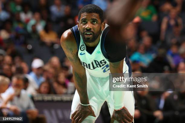 Kyrie Irving of the Dallas Mavericks looks on during the game against the Charlotte Hornets on March 26, 2023 at Spectrum Center in Charlotte, North...