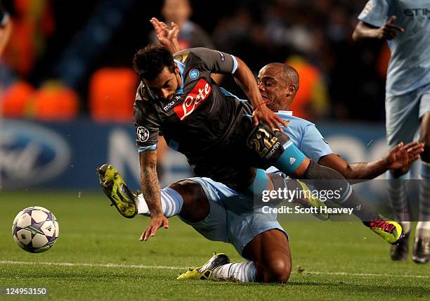 Vincent Kompany of Manchester City tangles with Ezequiel Lavezzi of Napoli during the UEFA Champions League Group A match between Manchester City and...