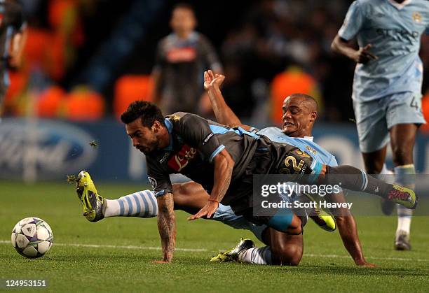 Vincent Kompany of Manchester City tangles with Ezequiel Lavezzi of Napoli during the UEFA Champions League Group A match between Manchester City and...