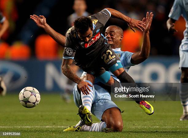 Vincent Kompany of Manchester City tangles with Ezequiel Lavezzi of Napoli during the UEFA Champions League Group A match between Manchester City and...