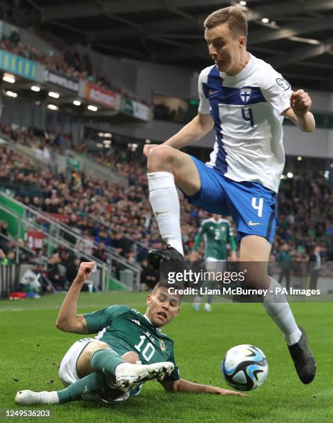 Northern Ireland's Dion Charles challenges Finland's Robert Ivanov during the UEFA Euro 2024 Group H qualifying match at Windsor Park Stadium,...