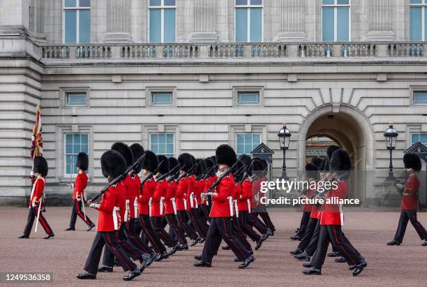 October 2022, Great Britain, London: Royal Guard soldiers march in front of Buckingham Palace for the changing of the guard. The changing of the...