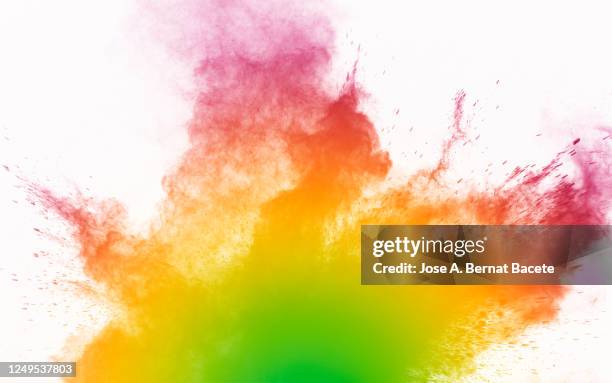 explosion by an impact of a cloud of particles of powder and smoke on a white background. - powder paint stock-fotos und bilder