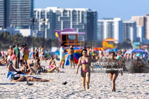 People lounge on South Beach during the fourth week of Spring Break in Miami Beach, Florida, on Saturday, March 25, 2023.